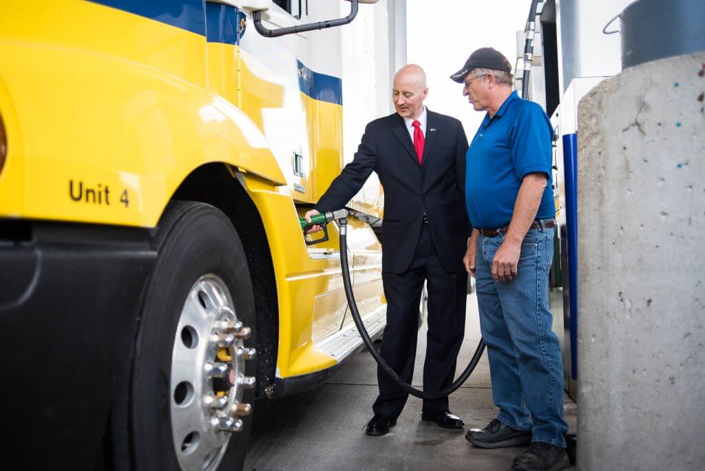 Governor Ricketts and JTL instructor fueling trucks