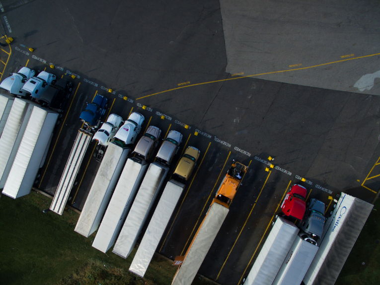 Overhead view of semi-trucks parked next to eachother